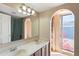 Bathroom with double vanity, teal shower curtain, and backyard view at 1865 W Keating Ave, Mesa, AZ 85202