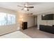 Bright bedroom with a large TV, dresser, and carpet flooring at 1865 W Keating Ave, Mesa, AZ 85202