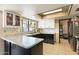 L-shaped kitchen with granite countertops and ample cabinet space at 1865 W Keating Ave, Mesa, AZ 85202