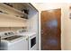 Laundry room with washer, dryer, and extra shelving at 1865 W Keating Ave, Mesa, AZ 85202