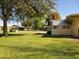 Photo shows a ranch style home with a large grassy backyard at 19002 N Signal Butte Cir, Sun City, AZ 85373