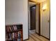 Hallway with bookcase and access to other rooms at 19002 N Signal Butte Cir, Sun City, AZ 85373