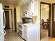 Kitchen with white cabinets, double oven, and view into dining area at 19002 N Signal Butte Cir, Sun City, AZ 85373