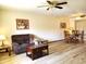 Living room featuring hardwood floors, a brown couch and a coffee table at 19002 N Signal Butte Cir, Sun City, AZ 85373