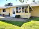 Shows a back patio with a door leading to the home and a small lawn at 19002 N Signal Butte Cir, Sun City, AZ 85373