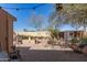 View of backyard with stone and concrete slab ground cover with an outdoor pergola at 19308 W Jefferson St, Buckeye, AZ 85326