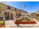 Landscaped backyard featuring a stone patio, raised garden bed, and pergola at 19308 W Jefferson St, Buckeye, AZ 85326