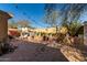 Landscaped backyard featuring a stone patio, garden beds, and a shaded pergola area at 19308 W Jefferson St, Buckeye, AZ 85326