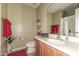 Traditional bathroom featuring a single sink vanity, toilet, and shower with framed mirror and neutral color palette at 19308 W Jefferson St, Buckeye, AZ 85326