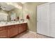 Bathroom features double sinks, cherry wood cabinets, and a large vanity mirror at 19308 W Jefferson St, Buckeye, AZ 85326