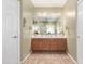 Bathroom with double sinks, lighting, and cabinets at 19308 W Jefferson St, Buckeye, AZ 85326