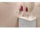 Charming powder room with a white vanity, decorative mirror and textured walls at 19308 W Jefferson St, Buckeye, AZ 85326