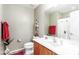 Neutral-toned bathroom features a white sink, toilet, and shower/tub combo with floral shower curtain at 19308 W Jefferson St, Buckeye, AZ 85326