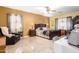 Well-lit bedroom with tiled flooring, ceiling fan, and a stylish decor at 19308 W Jefferson St, Buckeye, AZ 85326