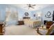 Bedroom with neutral color carpet, ceiling fan and beige bedding at 19308 W Jefferson St, Buckeye, AZ 85326