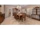 Elegant dining room featuring a large wooden table and chairs beneath a decorative chandelier, perfect for gatherings at 19308 W Jefferson St, Buckeye, AZ 85326