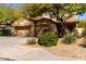 Inviting home featuring a three car garage and mature shade trees in a well kept front yard at 19308 W Jefferson St, Buckeye, AZ 85326