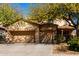 Inviting home featuring a three car garage and mature shade trees in a well kept front yard at 19308 W Jefferson St, Buckeye, AZ 85326