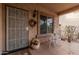 Inviting front porch with decorative wreath, seating, and a security screen door at 19308 W Jefferson St, Buckeye, AZ 85326