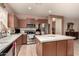 Kitchen showcases stainless steel appliances and a functional island with tile countertops at 19308 W Jefferson St, Buckeye, AZ 85326