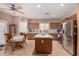 Bright, open kitchen with stainless steel appliances, tiled island, and an adjacent breakfast area for casual dining at 19308 W Jefferson St, Buckeye, AZ 85326