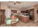 Open kitchen features tile floors, wooden cabinets, stainless steel appliances, and an island at 19308 W Jefferson St, Buckeye, AZ 85326