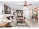 Cozy living room featuring tile floors, a ceiling fan, and comfortable sofas at 19308 W Jefferson St, Buckeye, AZ 85326