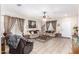 Bright living room with tile floors, stylish curtains, and comfortable beige sofas at 19308 W Jefferson St, Buckeye, AZ 85326