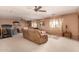 Bright living room with neutral carpet, ceiling fans, and comfortable seating arrangement at 19308 W Jefferson St, Buckeye, AZ 85326