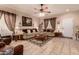 Cozy living room featuring tiled floors, a ceiling fan, and neutral colored walls at 19308 W Jefferson St, Buckeye, AZ 85326