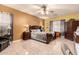 Comfortable main bedroom with decorative ceiling fan, tile floors, and warm, inviting colors at 19308 W Jefferson St, Buckeye, AZ 85326