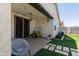 Covered back patio with string lights and furniture overlooking the artificial turf at 19756 W Roma Ave, Litchfield Park, AZ 85340