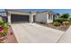 Attractive single-story home featuring a two-car garage and desert landscaping at 19756 W Roma Ave, Litchfield Park, AZ 85340