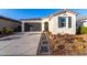 Single-story home with a two-car garage and nicely landscaped front yard at 19756 W Roma Ave, Litchfield Park, AZ 85340