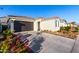 Front view of a single story home with desert landscaping and a two car garage at 19756 W Roma Ave, Litchfield Park, AZ 85340