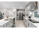 Modern kitchen with white cabinets, stainless steel appliances, and a large island at 19756 W Roma Ave, Litchfield Park, AZ 85340