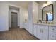 Elegant bathroom with double vanity, tall storage cabinet and wood flooring at 20628 E Natalie Way, Queen Creek, AZ 85142