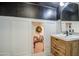 Modern bathroom with wooden vanity, white sink, and hidden storage area at 20628 E Natalie Way, Queen Creek, AZ 85142