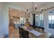 Open concept dining room with farmhouse style table and kitchen views at 20628 E Natalie Way, Queen Creek, AZ 85142