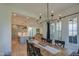 Spacious dining room featuring a farmhouse table, chandelier, and open kitchen view at 20628 E Natalie Way, Queen Creek, AZ 85142