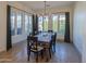 Formal dining room with a rustic wood table and large windows at 20628 E Natalie Way, Queen Creek, AZ 85142