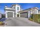 Modern home with gray and white exterior, landscaped front yard, and a two-car garage at 20628 E Natalie Way, Queen Creek, AZ 85142