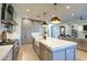 Open concept kitchen with island seating and a view into the living room at 20628 E Natalie Way, Queen Creek, AZ 85142