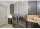 Convenient laundry room with front-load washer and dryer, stylish tile backsplash at 20628 E Natalie Way, Queen Creek, AZ 85142