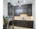 Laundry room with dark cabinetry, geometric patterned tile backsplash, and new washer/dryer at 20628 E Natalie Way, Queen Creek, AZ 85142