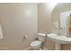 Clean bathroom with pedestal sink and toilet at 2212 E Sunland Ave, Phoenix, AZ 85040