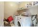 Laundry room with washer, dryer, and shelving at 2212 E Sunland Ave, Phoenix, AZ 85040