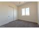 Bedroom with double door closet and window offering natural light at 2383 E Cana Ln, Casa Grande, AZ 85194