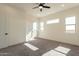 Bright bedroom with carpeting, ceiling fan, and access to patio at 2383 E Cana Ln, Casa Grande, AZ 85194