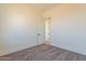 Simple bedroom with carpet, neutral walls and door to the hallway at 2383 E Cana Ln, Casa Grande, AZ 85194